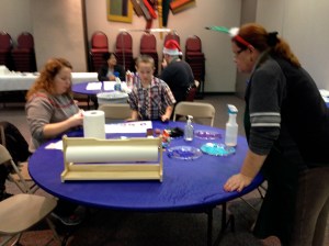 Susan Murray assisting with creating wrapping papr